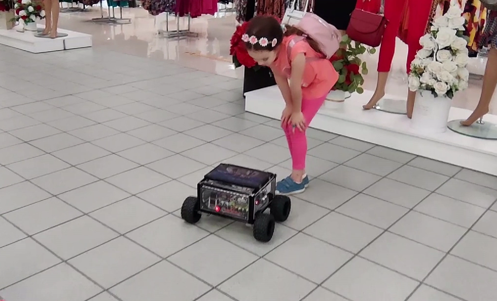 fetiță care interacționează cu un robot cu teleprezență